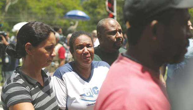 People wait for information in front of the Flamengo soccer clubu2019s training centre, after a deadly fire, in Rio de Janeiro, Brazil, yesterday.