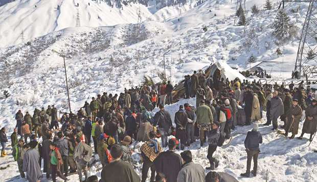Local residents along with security personnel search for the missing policemen after a snow avalanche hit a police post at the Jawahar Tunnel in Kulgam district, some 90km from Srinagar, yesterday.
