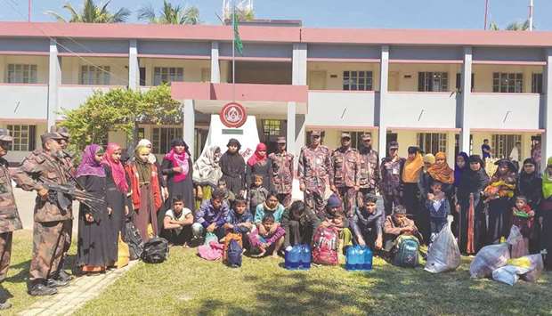 Rescued Rohingya refugees pose for photographs at the Border Guard Bangladesh camp in Teknaf yesterday.