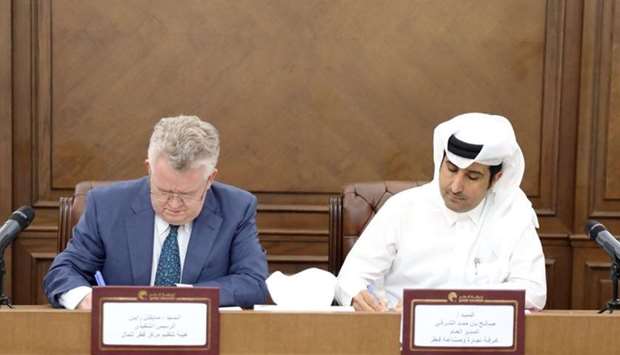 Saleh Bin Hamad Al Sharqi, Director General of the QCCI and Michael G. Ryan, Chief Executive Officer of the Regulatory Authority, sign the MoU.
