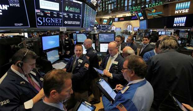 Traders work on the trading floor at the New York Stock Exchange