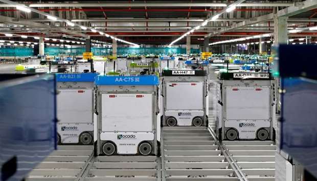 Robots are seen on the grid of the ,smart platform, at the Ocado warehouse at Andover