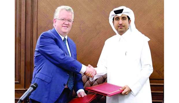 QFC Regulatory Authority CEO Michael G Ryan and Qatar Chamber director general Saleh bin Hamad al-Sharqi shaking hands after signing the MoU.