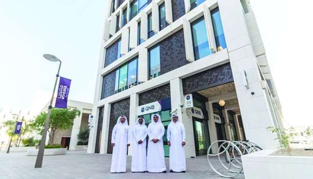 QNB executives in front of the bank's building ocated adjacent to MDDu2019s underpass to Souq Waqif.rnrn