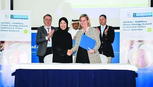 HE Dr Hanan Mohamed al-Kuwari, Minister of Public Health, and Prof Dr Annette Gruters-Kieslich, shake hands at the signing ceremony.