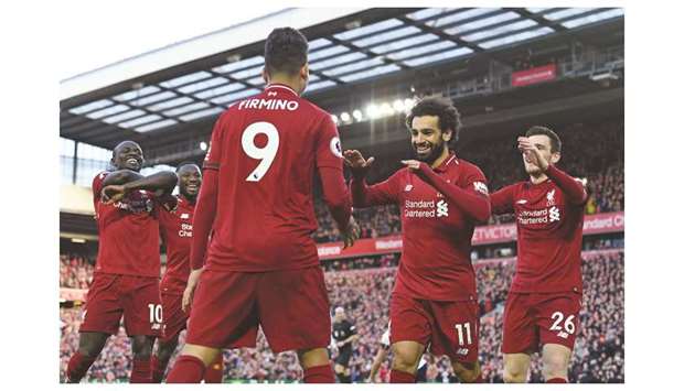 Liverpoolu2019s Mohamed SLalah (second right) celebrates with teammates after scoring against Bournemouth during the Premier League match at Anfield. (AFP)