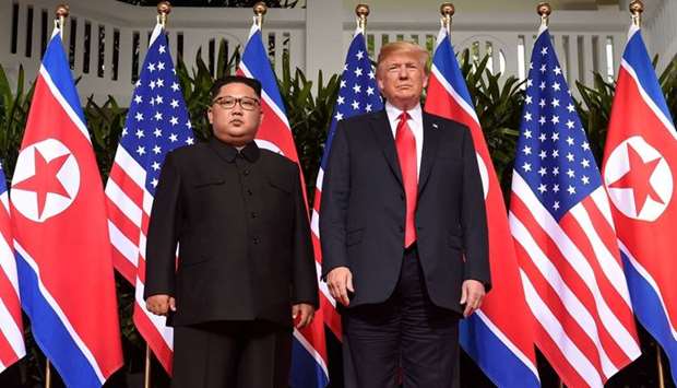 US President Donald Trump (R) posing with North Korea's leader Kim Jong Un (L) at the start of their historic US-North Korea summit, at the Capella Hotel on Sentosa island in Singapore. File photo:June 12, 2018