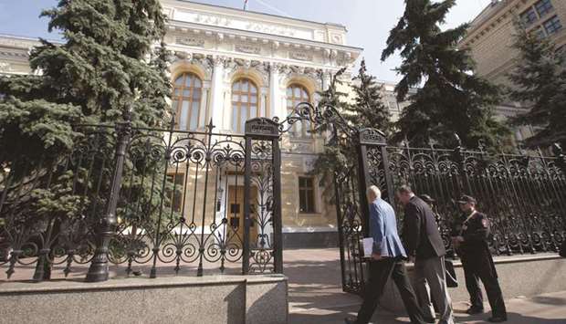 Visitors pass security to enter the headquarters of Russiau2019s central bank in Moscow. The Bank of Russia lowered its benchmark interest rate by 25 basis points to 6%, taking the total reduction in the past year to 175 basis points.
