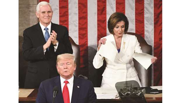 Vice-President Mike Pence applauds as Speaker of the House of Representatives Nancy Pelosi appears to rip a copy of President Donald Trumpu2019s speech after he delivered the State of the Union address at the US Capitol in Washington, DC.