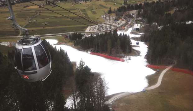 Cable car cabins travel over artificial snow on a ski slope at the Alpine skiing resort in Garmisch-Partenkirchen, Germany, on January 8. Last month was the hottest January ever in Europe, the Copernicus Climate Change Service reported. Surface temperatures were 3.1 degrees Celsius (5.6 degrees Fahrenheit) warmer than average.