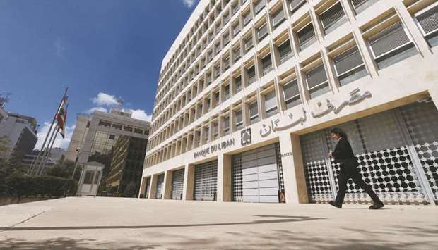 A woman walks outside of Lebanonu2019s central bank building in Beirut (file). Despite a spotless record of servicing international debt, consensus is fraying in Lebanon as almost $3.5bn in Eurobond principal and interest payments come due by June.