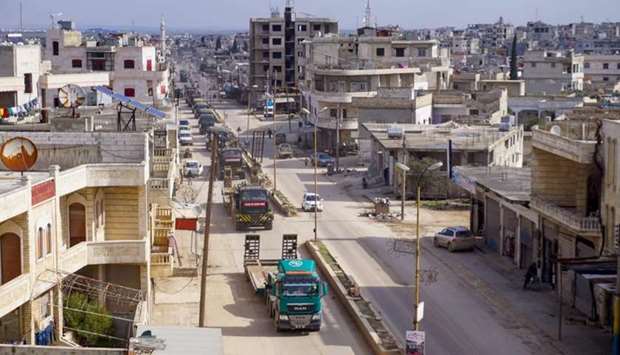 A Turkish military convoy passes through the town of Binnish in Syriau2019s northwestern province of Idlib, near the Syria-Turkey border