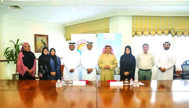 Qatar Red Crescent Society and Qatar Scientific Club officials at the agreement signing ceremony.