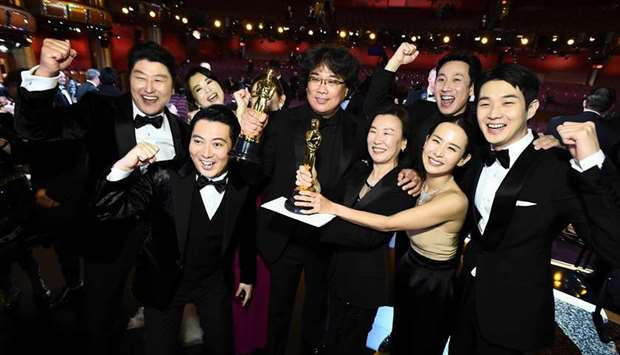 ONE BIG PARTY: Best Director award winner Bong Joon-ho poses backstage with the cast of Parasite during the 92nd Annual Academy Awards at the Dolby Theatre in Hollywood, California. AFP