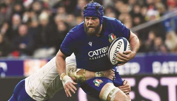 Italyu2019s lock Dean Budd (right) is tackled during the Six Nations match against France at the Stade de France in Saint-Denis, Paris, on Monday. (AFP)