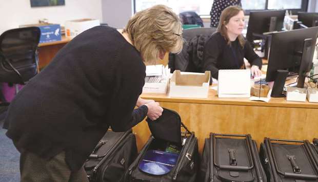 Nashua City clerk Susan Lovering looks inside one of the supply totes for election precinct moderators ahead of todayu2019s New Hampshire presidential primary election in Nashua, New Hampshire.