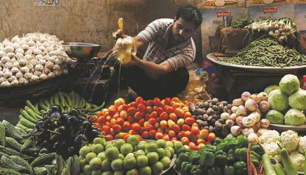 A vegetable seller sprinkles water to keep them fresh and shine at a makeshift stall along a market in Karachi. The general inflation in Pakistan measured by consumer price indicator increased by 14.6% in January over the same month of last year, according to a recent data collected by the governmentu2019s own Pakistan Bureau of Statistics.