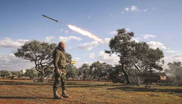 A Syrian rebel fighter remotely-fires a rocket from a truck-mounted launcher at a position in the countryside of Idlib towards regime force positions in the southern countryside of Aleppo province, yesterday.