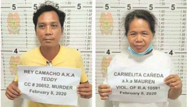 Rey Camacho, 51, and his wife, Carmelita, 48, pose for a photo at the Bohol Provincial Police Office after their arrest in Tulang, Getafe.
