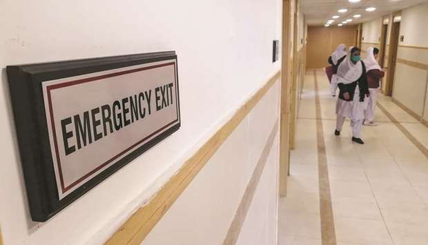Medical staff members wearing protective masks prepare rooms in an isolation ward at the Pakistan Institute of Medical Sciences (PIMS) hospital in Islamabad as a preventative measure following the coronavirus outbreak.