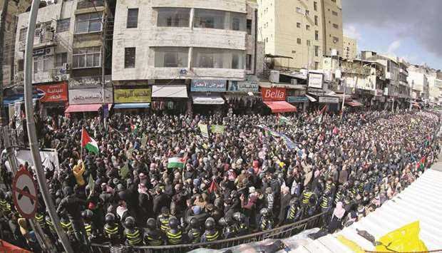 Jordanians take to the streets of Amman, in front of the Al-Husseini mosque in the centre of the capital, to protest against the US-brokered proposal for a settlement of the Middle East conflict, yesterday.