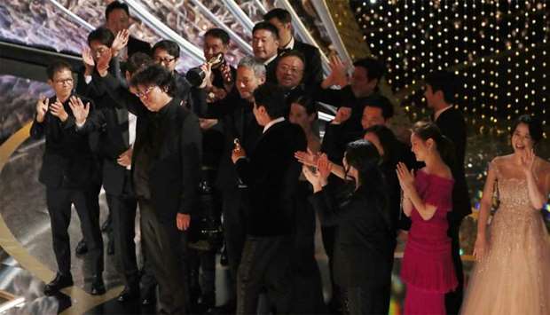 Director Bong Joon Ho and the cast and crew of \"Parasite\" on stage after winning the Oscar for Best Picture at the 92nd Academy Awards in Hollywood, Los Angeles