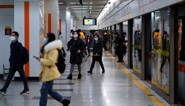 People wearing face masks are seen at a subway station in Shanghai