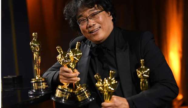 South Korean film director Bong Joon Ho poses with his engraved awards as he attends the 92nd Oscars Governors Ball at the Hollywood & Highland Center in Hollywood, California