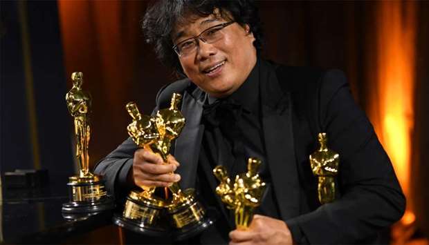 South Korean film director Bong Joon Ho poses with his engraved awards as he attends the 92nd Oscars Governors Ball at the Hollywood & Highland Center in Hollywood