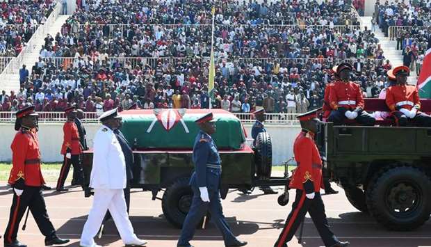 Military officers escort a gun carriage carrying the coffin of late former Kenya President, Daniel Arap Moi, draped in the Kenya national flag, during a state memorial service in Nairobi