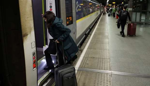 A woman enters a Eurostar train travelling from London to Paris, in London, Britain
