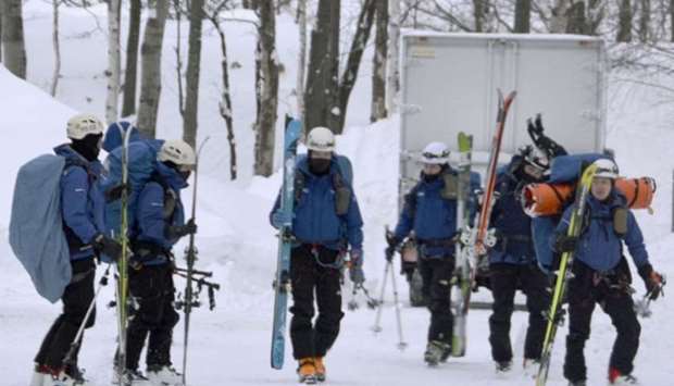 Mountain rescuers prepare to head for work at the Tomamu ski resort area in Shimukappu in Hokkaido, northern Japan, after eight French people were caught in an avalanche there the previous day, in this photo taken by Kyodo yesterday. Kyodo/via REUTERS.