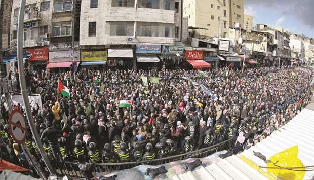 Jordanians take to the streets of Amman, in front of the Al-Husseini mosque in the centre of the capital, to protest against the US-brokered proposal for a settlement of the Middle East conflict, yesterday.
