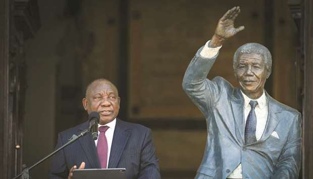 South Africau2019s President Cyril Ramaphosa speaks beside a statue of Nelson Mandela from the balcony where the anti-apartheid icon gave his first speech after his release from prison 30 years ago, in Cape Town, yesterday.