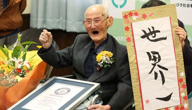 Chitetsu Watanabe, aged 112, poses next to the calligraphy reading in Japanese 'World Number One' after he was awarded as the world's oldest living male in Joetsu, Niigata prefecture. AFP/2019 GUINNESS WORLD RECORDS LTD./JIJI PRESS