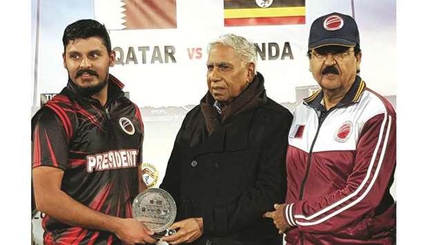 President Elevenu2019s Mirza Baig (left) receives the man-of-the-match award from QCA Operations Manager Manzoor Ahmad.