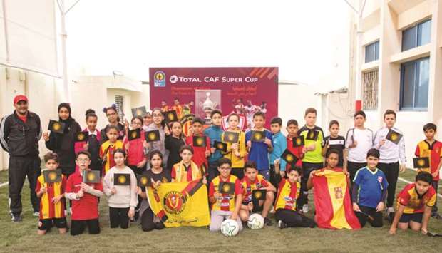 Tunisian School students in Doha pose with the CAF Super Cup Trophy during the trophy tour.
