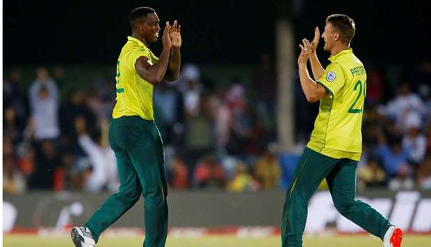 South Africau2019s Lungi Ngidi (left) celebrates taking the wicket of Englandu2019s Ben Stokes with teammate Dwaine Pretorius during their Twenty20 match at the Buffalo Park in East London, South Africa, yesterday. (Reuters)