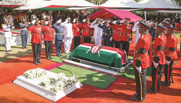 Members of the Kenya Defence Forces (KDF) salute the coffin of late former president Daniel Arap Moi, draped with the national flag, during the burial at his Kabarak home in Nakuru county, yesterday.
