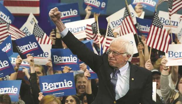 Democratic presidential hopeful Vermont Senator Bernie Sanders waves to supporters at the SNHU Field House in Manchester, New Hampshire, on Tuesday night.