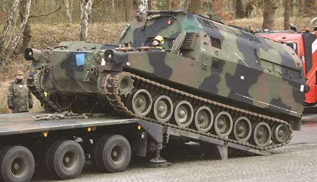 German Army soldiers load a US M992 support vehicle onto a heavy goods transporter during preparations for the Defender-Europe 20 international military exercises in Bergen Hohne, Germany.