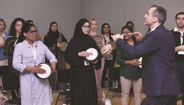 Participants take part in a drumming exercise at a music therapy workshop held in a collaboration between WCM-Q and QMA.