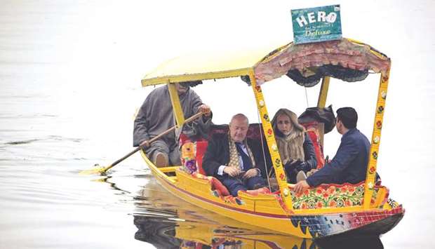 Envoys from foreign countries ride on a shikara boat in Dal Lake in Srinagar yesterday.