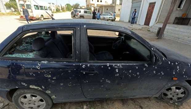 A car after a shell landed in a residential neighbourhood near Tripoli University in the Libyan capital