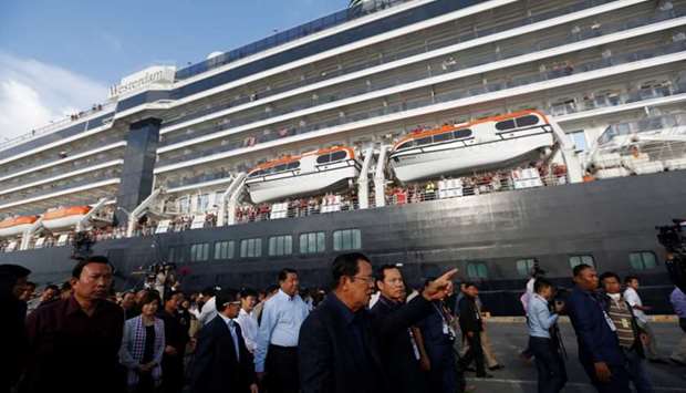 Cambodia's Prime Minister Hun Sen welcomes passenger of MS Westerdam, a cruise ship that spent two weeks at sea after being turned away by five countries over fears that someone aboard might have the coronavirus, as it docks in Sihanoukville, Cambodia