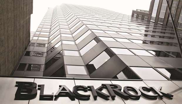 A BlackRock logo hangs above the entrance to its headquarters building in New York. BlackRock said it would exit debt and equity investments in thermal coal producers across its active portfolios.
