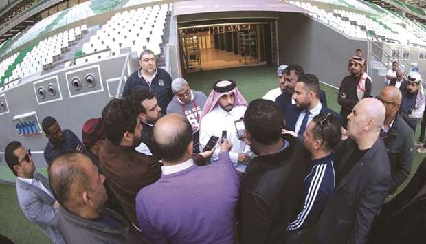 SCu2019s Education City Stadium Project Manager Eid al-Qahtani (centre) speaks to the media during a tour of the Education City Stadium (above).