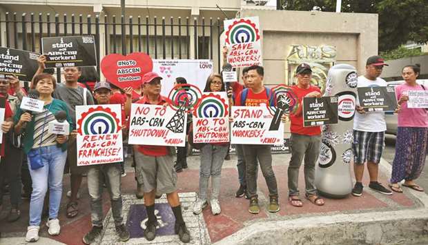 Supporters hold placards during a protest in support of local broadcast giant ABS-CBN in Manila, yesterday.