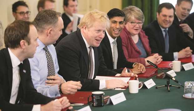 Prime Minister Boris Johnson speaks during his first cabinet meeting next to a new appointed Chancellor of the Exchequer Rishi Sunak, following a reshuffle the day  before, at Downing Street in London yesterday.