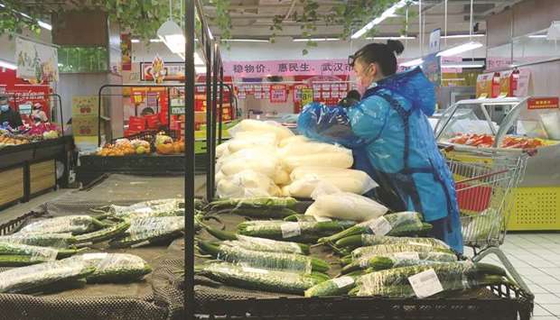 An employee sorts vegetables inside a supermarket in Wuhan, the epicentre of the novel coronavirus outbreak, in Hubei province, China, yesterday.